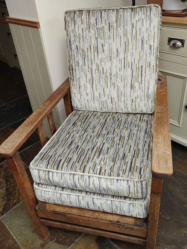New Ercol dining chair cushions showing the webbing and stud fastenings
